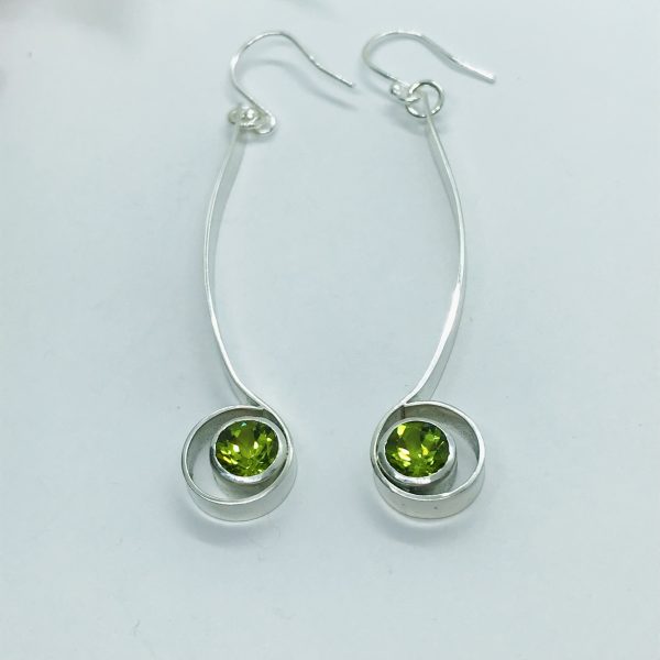 Peridot drop earrings on white background