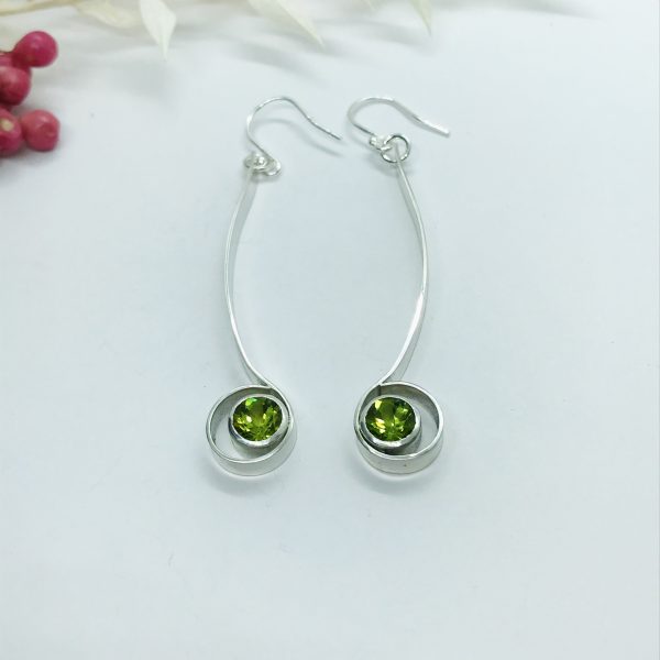 Peridot drop earrings on white background