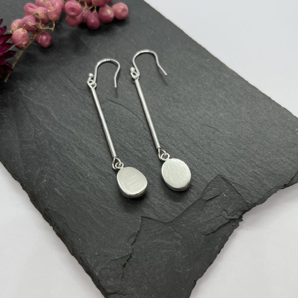 Black Tourmaline drop earrings on grey tile