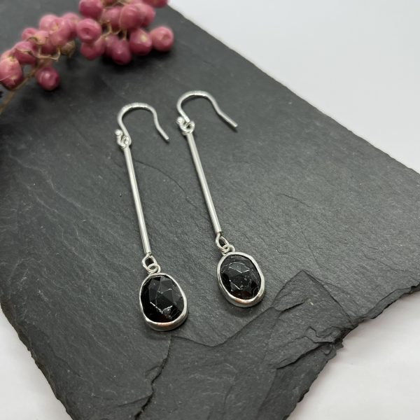 Black Tourmaline drop earrings on grey tile